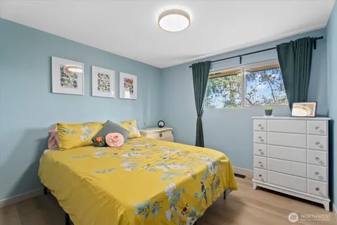 a bed sitting in a bedroom next to a window