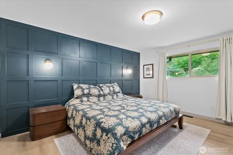a large bed sitting in a bedroom next to a window