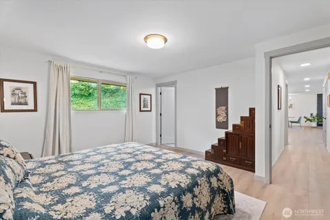 a bedroom with a large bed and a window