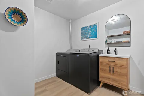 wooden floor with a stove and a painting on the wall