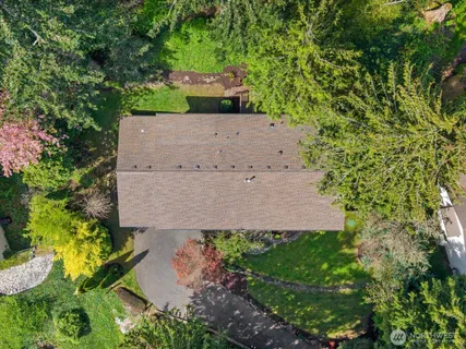 an aerial view of a house with a yard