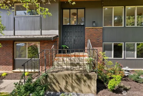 a view of a house with a small yard and plants