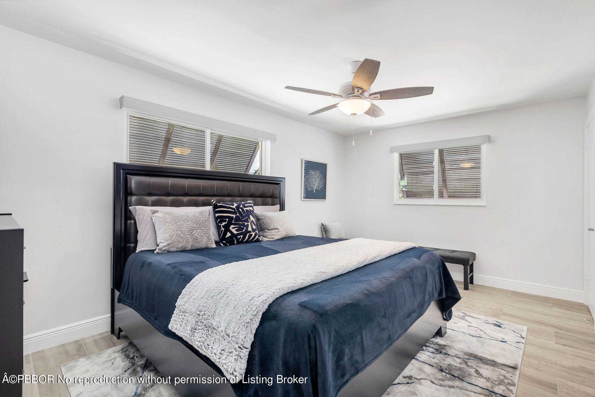 1408 Indian Road East West Palm Beach, FL 33406 - Photo 23 of 50 a bedroom with a large bed and a ceiling fan