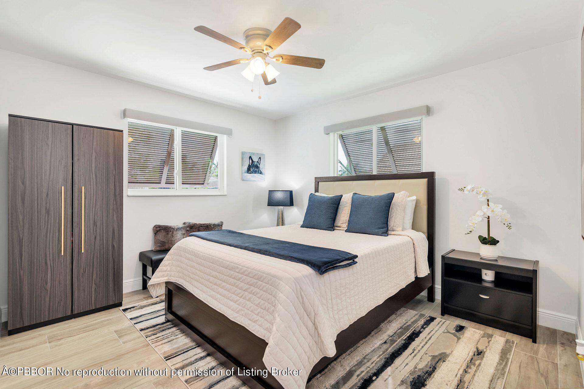 1408 Indian Road East West Palm Beach, FL 33406 - Photo 25 of 50 a bedroom with a bed and a chandelier