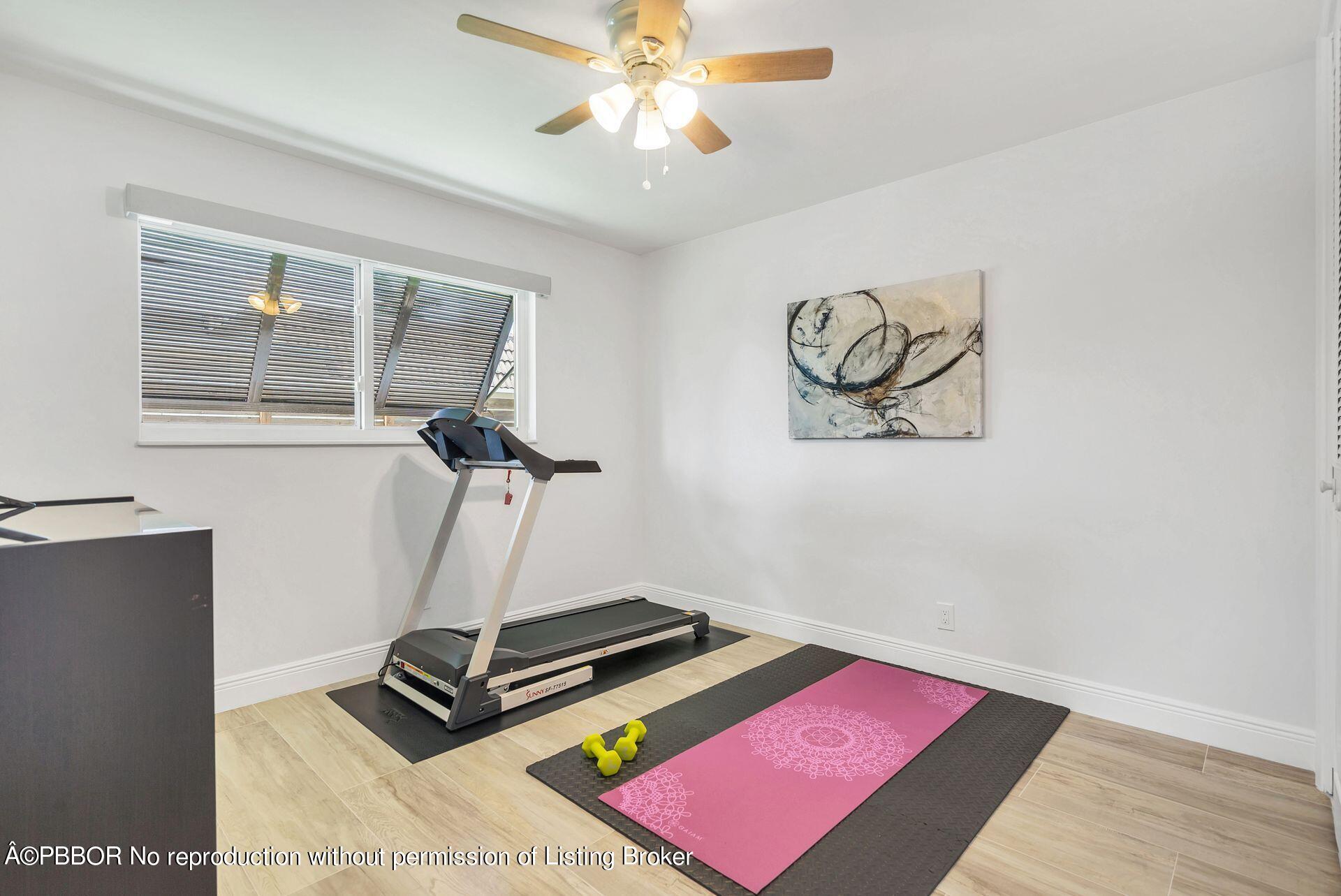 1408 Indian Road East West Palm Beach, FL 33406 - Photo 27 of 50 a room with gym equipment and wooden floor