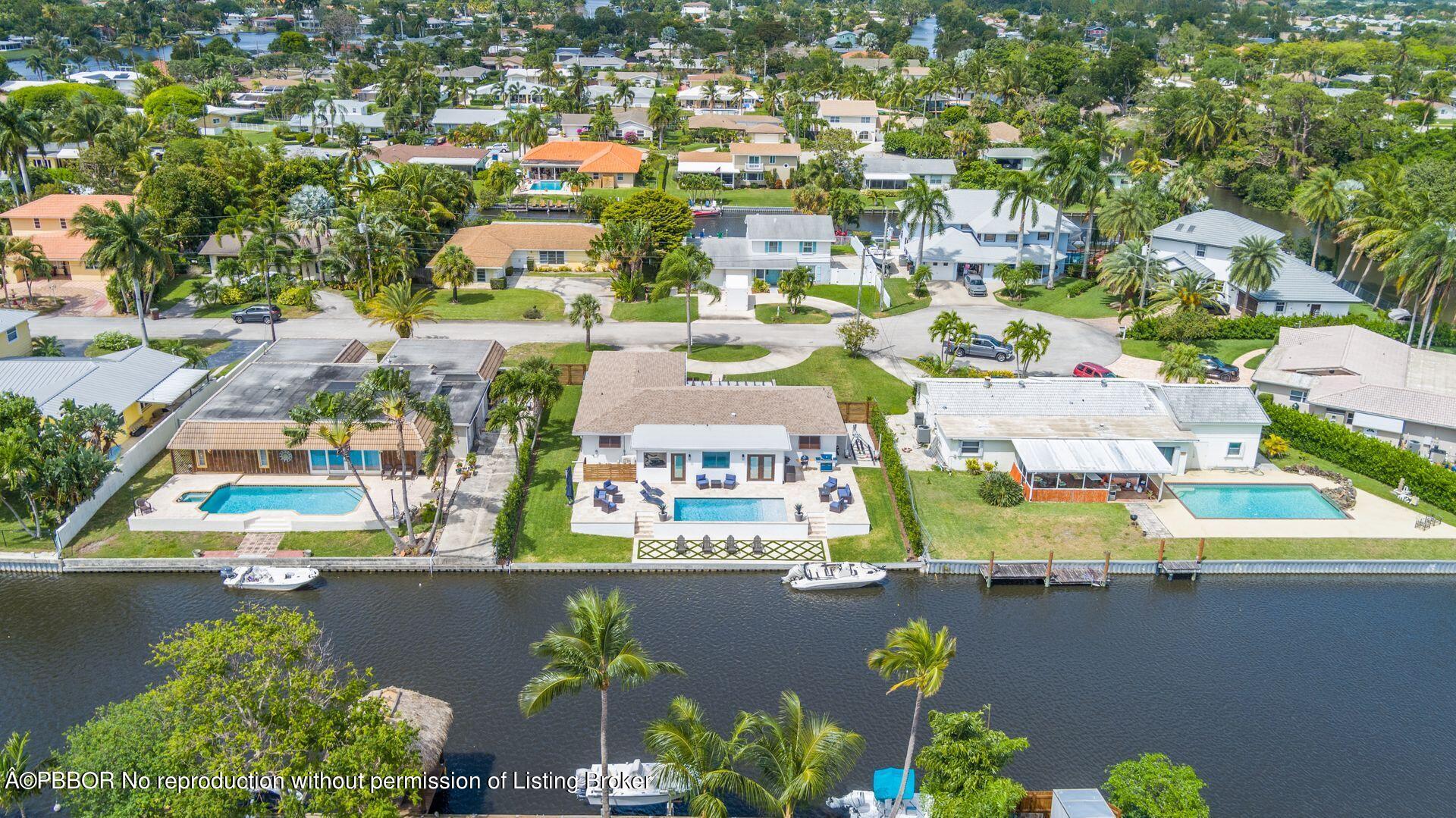 1408 Indian Road East West Palm Beach, FL 33406 - Photo 46 of 50 an aerial view of a city with lots of residential buildings ocean and mountain view in back