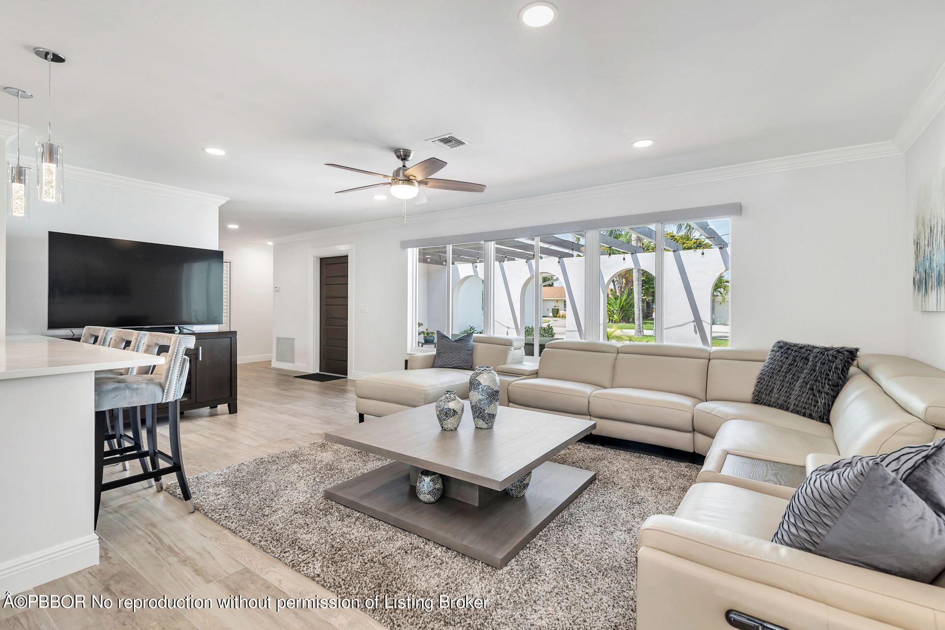 1408 Indian Road East West Palm Beach, FL 33406 - Photo 6 of 50 a living room with furniture and a flat screen tv