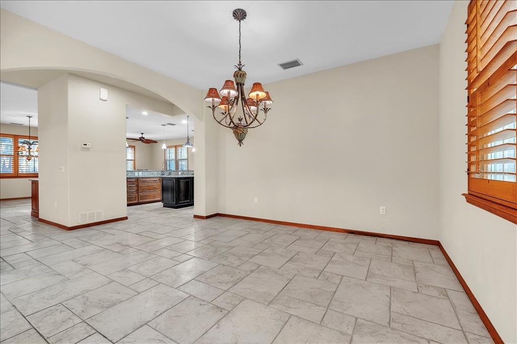 10597 Southwest Kissimmee Road Arcadia, FL 34269 - Photo 11 of 54 a view of a big room with windows and chandelier