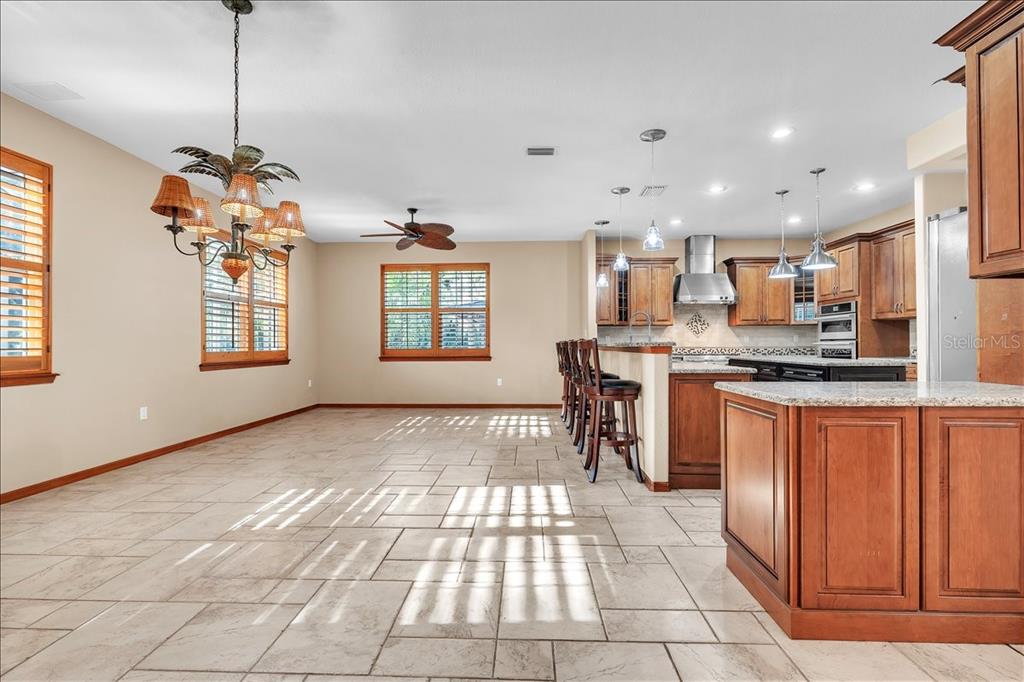 10597 Southwest Kissimmee Road Arcadia, FL 34269 - Photo 12 of 54 a kitchen with stainless steel appliances granite countertop a refrigerator and a stove top oven