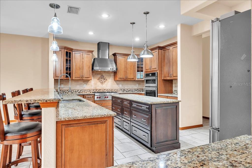 10597 Southwest Kissimmee Road Arcadia, FL 34269 - Photo 15 of 54 a kitchen with stainless steel appliances granite countertop a sink stove and refrigerator