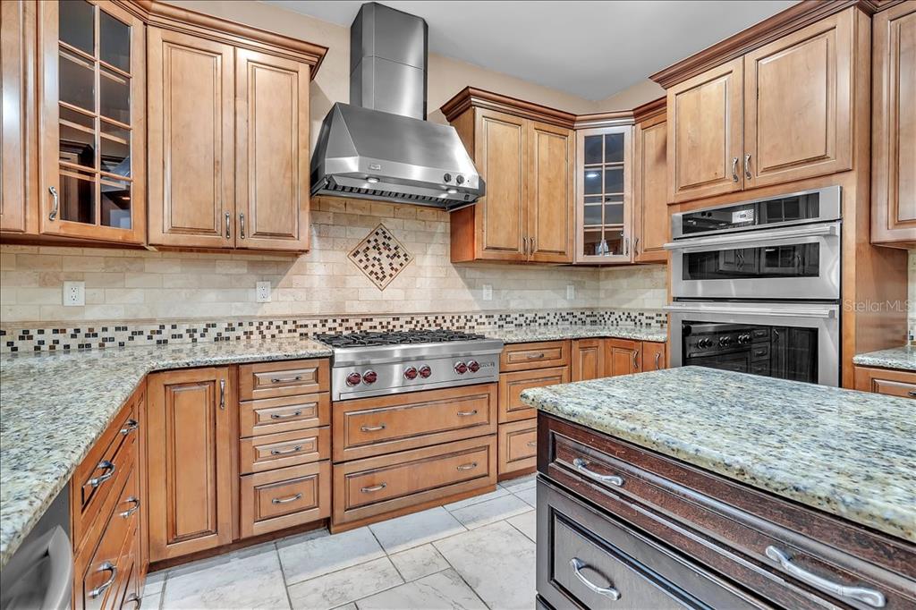 10597 Southwest Kissimmee Road Arcadia, FL 34269 - Photo 16 of 54 a kitchen with granite countertop a sink stove and cabinets