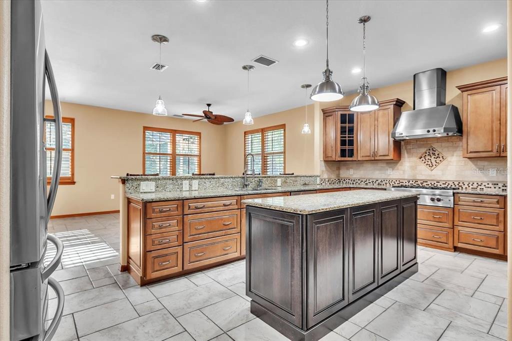10597 Southwest Kissimmee Road Arcadia, FL 34269 - Photo 17 of 54 a kitchen with stainless steel appliances granite countertop a sink and a stove