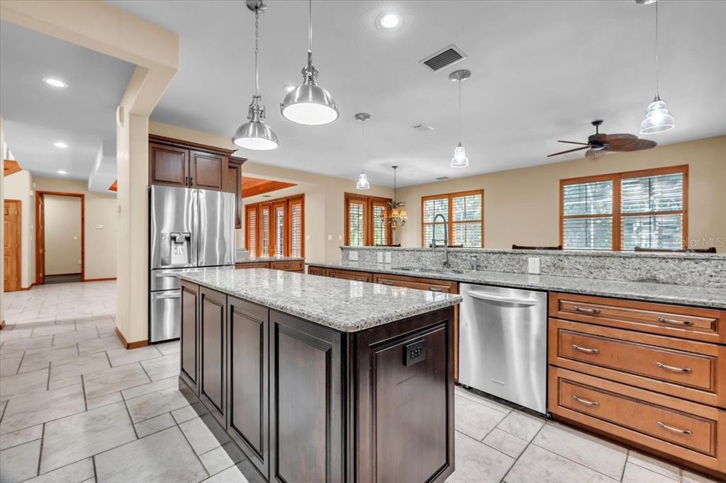 10597 Southwest Kissimmee Road Arcadia, FL 34269 - Photo 18 of 54 a kitchen with stainless steel appliances granite countertop stove top oven and cabinets