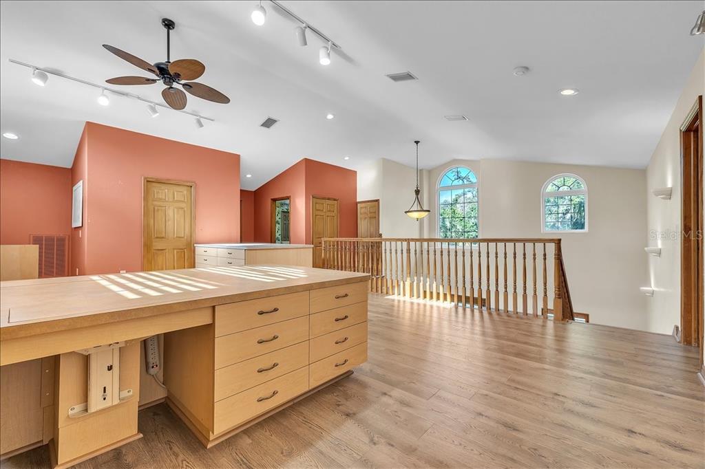 10597 Southwest Kissimmee Road Arcadia, FL 34269 - Photo 31 of 54 a view of a room with wooden floor and a ceiling fan