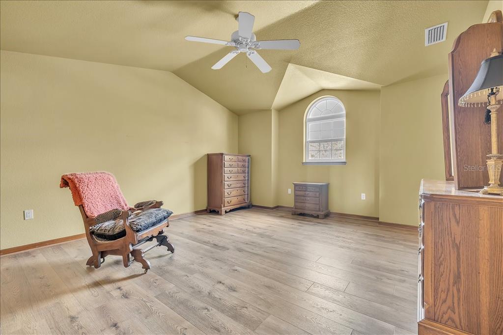 10597 Southwest Kissimmee Road Arcadia, FL 34269 - Photo 34 of 54 a living room with furniture and a chandelier