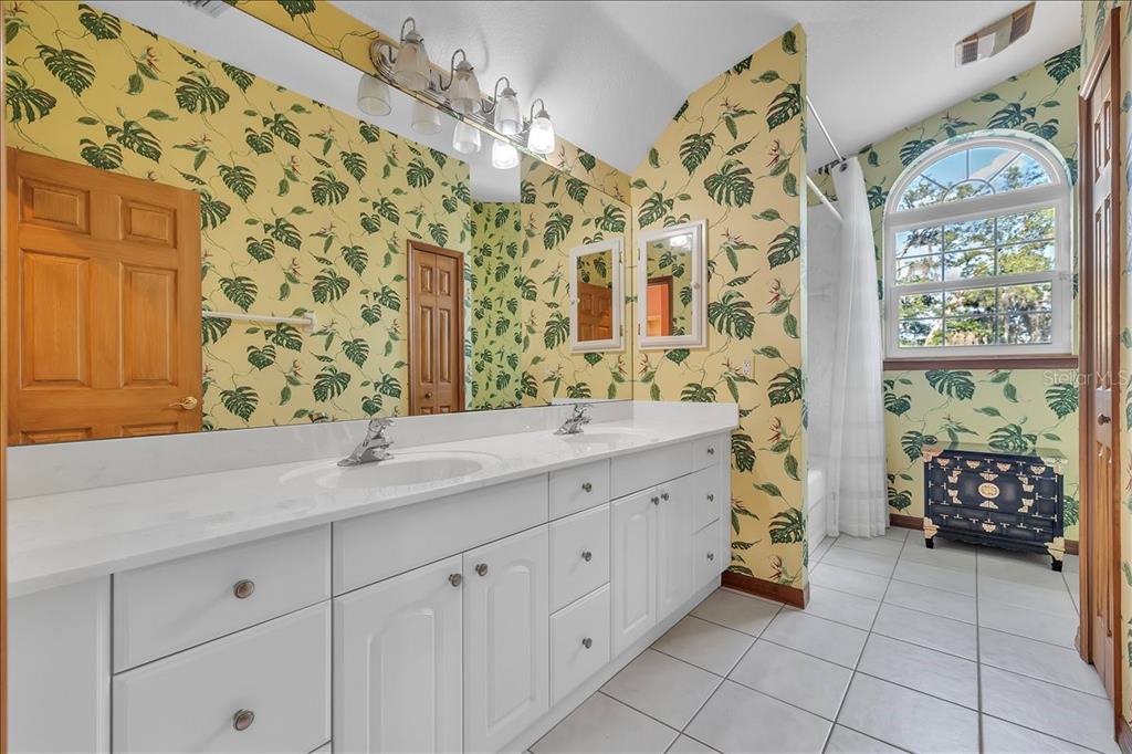 10597 Southwest Kissimmee Road Arcadia, FL 34269 - Photo 36 of 54 a bathroom with a sink mirror and a shower