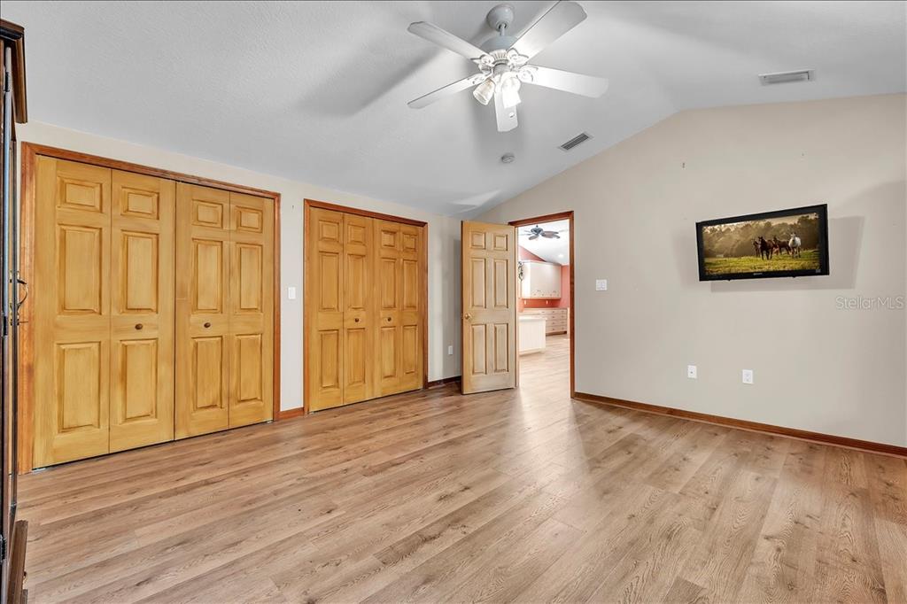 10597 Southwest Kissimmee Road Arcadia, FL 34269 - Photo 39 of 54 a view of an empty room with a window and wooden floor