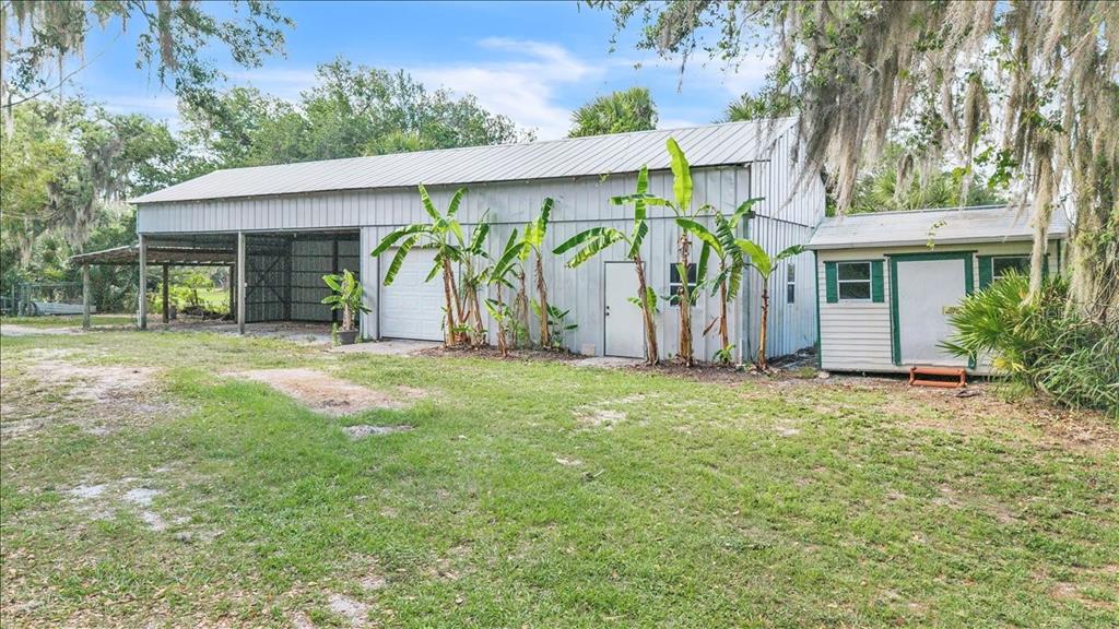 10597 Southwest Kissimmee Road Arcadia, FL 34269 - Photo 46 of 54 a view of a house with a yard