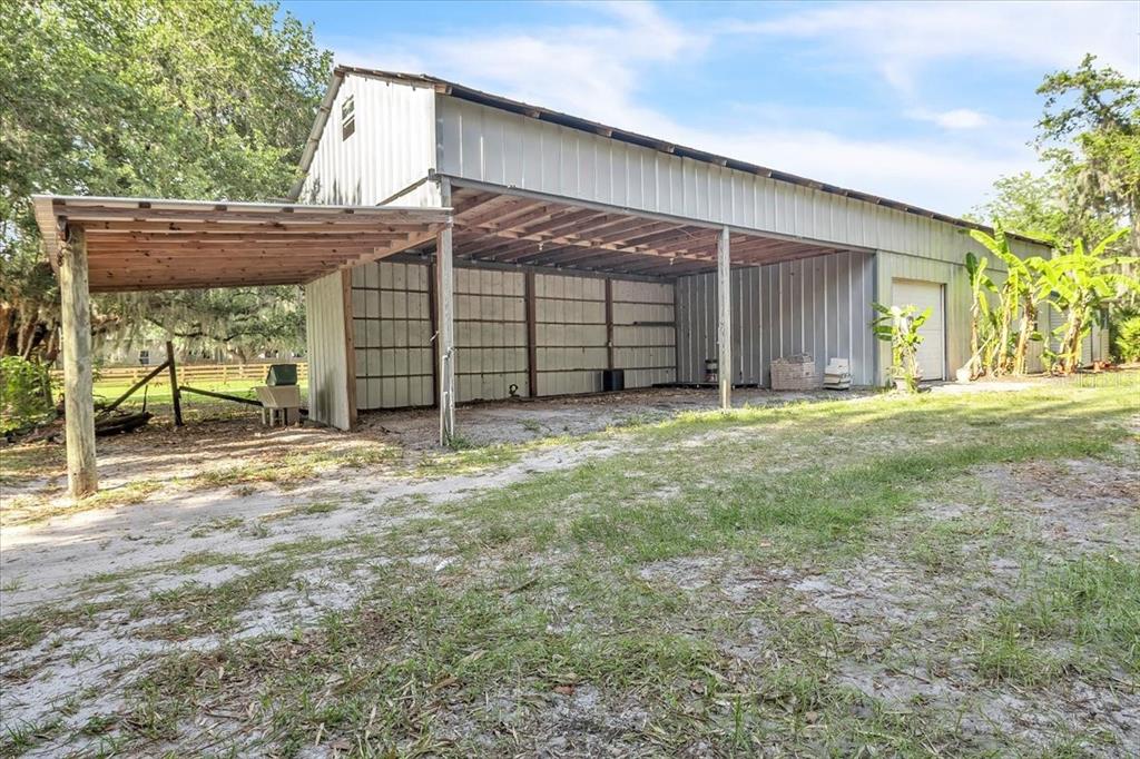 10597 Southwest Kissimmee Road Arcadia, FL 34269 - Photo 49 of 54 a view of a house with a yard and garage