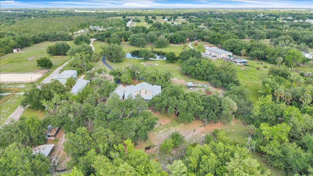 10597 Southwest Kissimmee Road Arcadia, FL 34269 - Photo 51 of 54 an aerial view of residential houses with outdoor space and trees