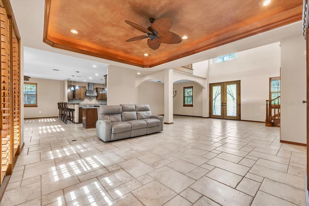10597 Southwest Kissimmee Road Arcadia, FL 34269 - Photo 9 of 54 a living room with furniture and a chandelier