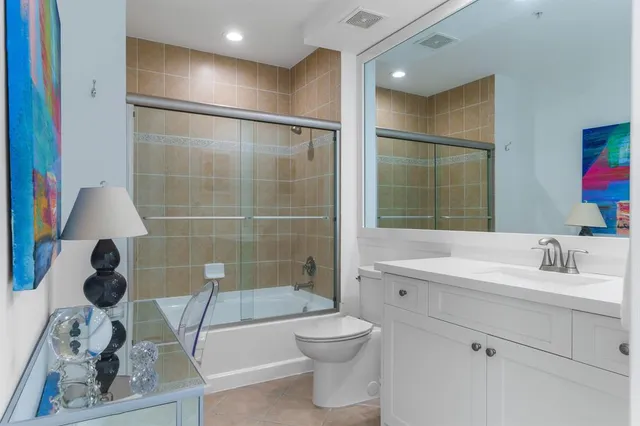 a room with painting on the wall and a potted plant