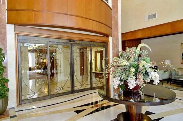 a dining room with furniture a chandelier and a rug