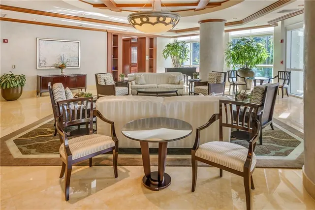 a view of a dining room with furniture and a chandelier
