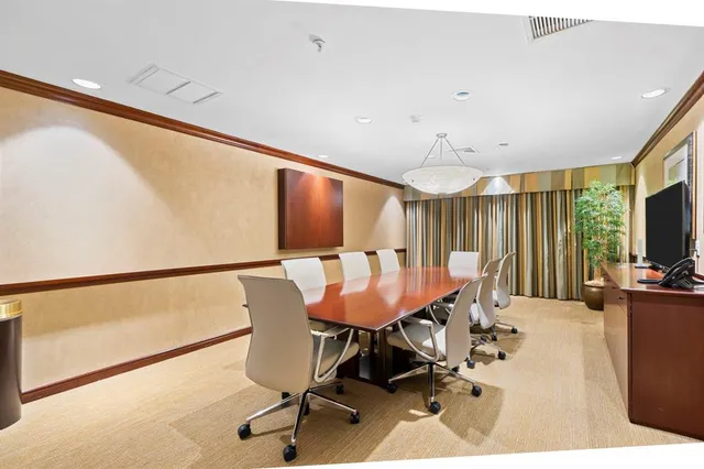 a room with furniture pool table wooden floor and windows