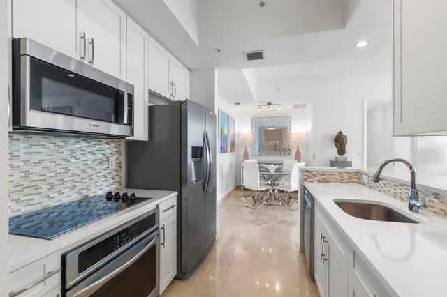 a kitchen with stainless steel appliances a refrigerator and a sink