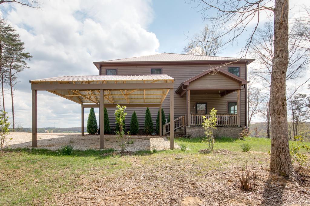 55 Cooley's Rift Boulevard Monteagle, TN 37356 - Photo 24 of 30 a view of a house with a backyard and a large tree