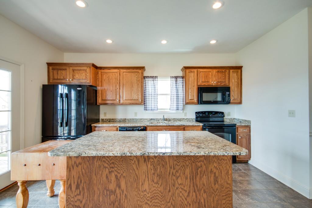 55 Cooley's Rift Boulevard Monteagle, TN 37356 - Photo 5 of 30 a kitchen with granite countertop a sink and a refrigerator