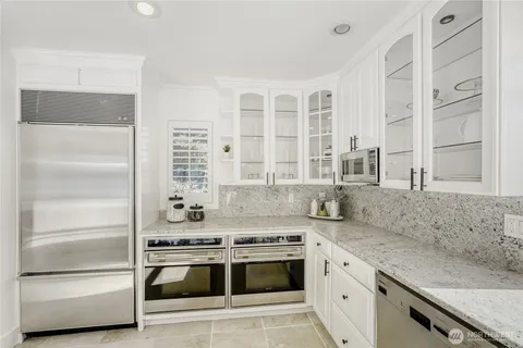 a kitchen with stainless steel appliances granite countertop a stove and a sink