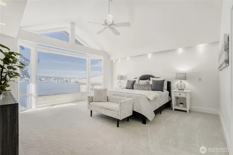 a spacious bedroom with a bed and a chandelier
