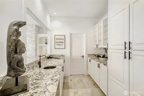a kitchen with a stove a refrigerator and cabinets