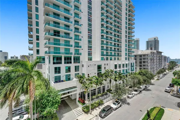 a view of a building with garden and tall buildings
