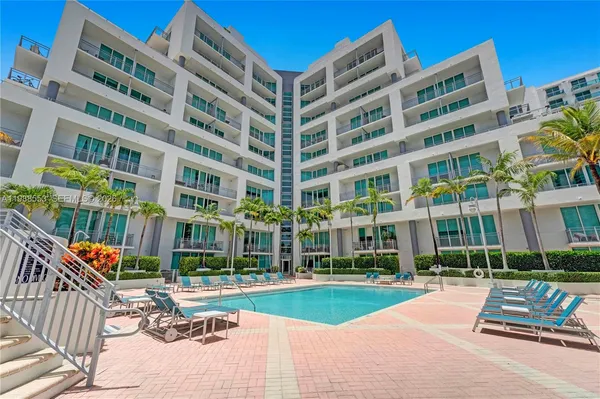 a swimming pool with outdoor seating and yard