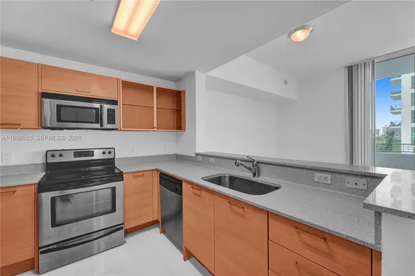 a kitchen that has a sink and a stove