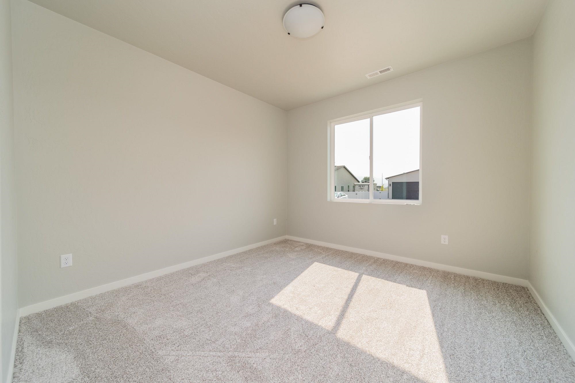 1614 Tungsten Way Fruita, CO 81521 - Photo 13 of 16 an empty room with a window
