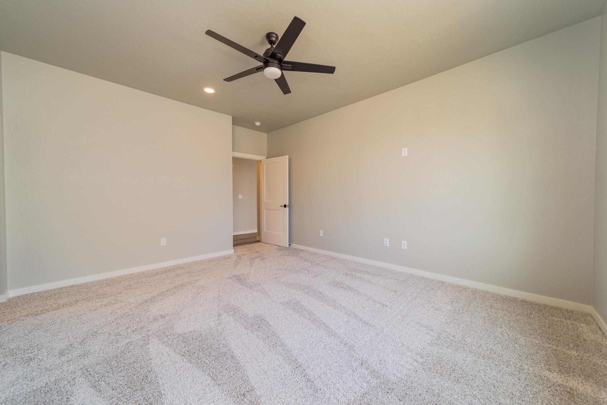 1614 Tungsten Way Fruita, CO 81521 - Photo 2 of 16 an empty room with a ceiling fan and window