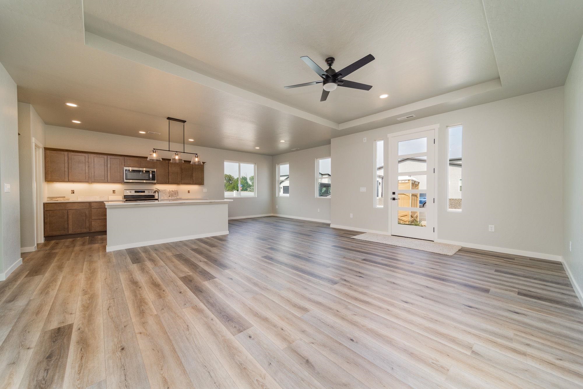 1614 Tungsten Way Fruita, CO 81521 - Photo 6 of 16 a view of a kitchen with a sink and dishwasher a refrigerator with wooden floor
