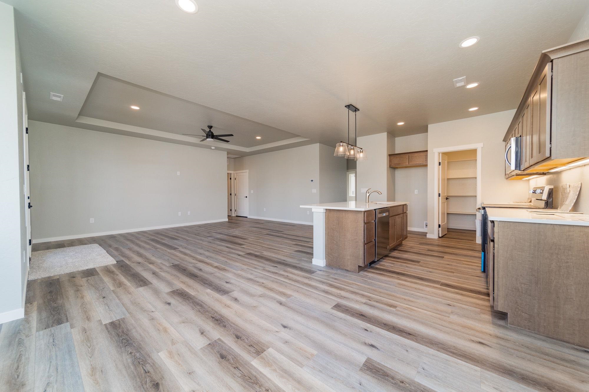 1614 Tungsten Way Fruita, CO 81521 - Photo 8 of 16 a view of a kitchen with wooden floor and a sink