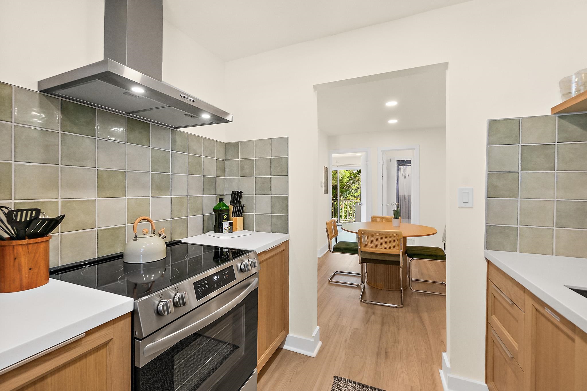 405 Flagler Boulevard, Unit 8A St. Augustine, FL 32080 - Photo 12 of 35 a kitchen with a stove and a wooden floor