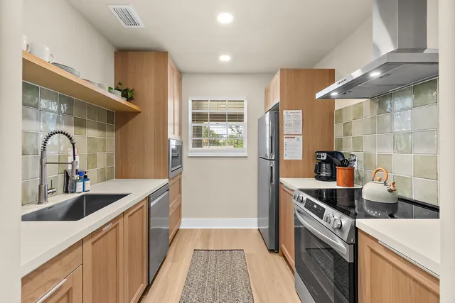 a kitchen with granite countertop a sink and a stove top oven