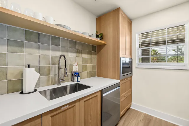 a kitchen with a sink and a refrigerator