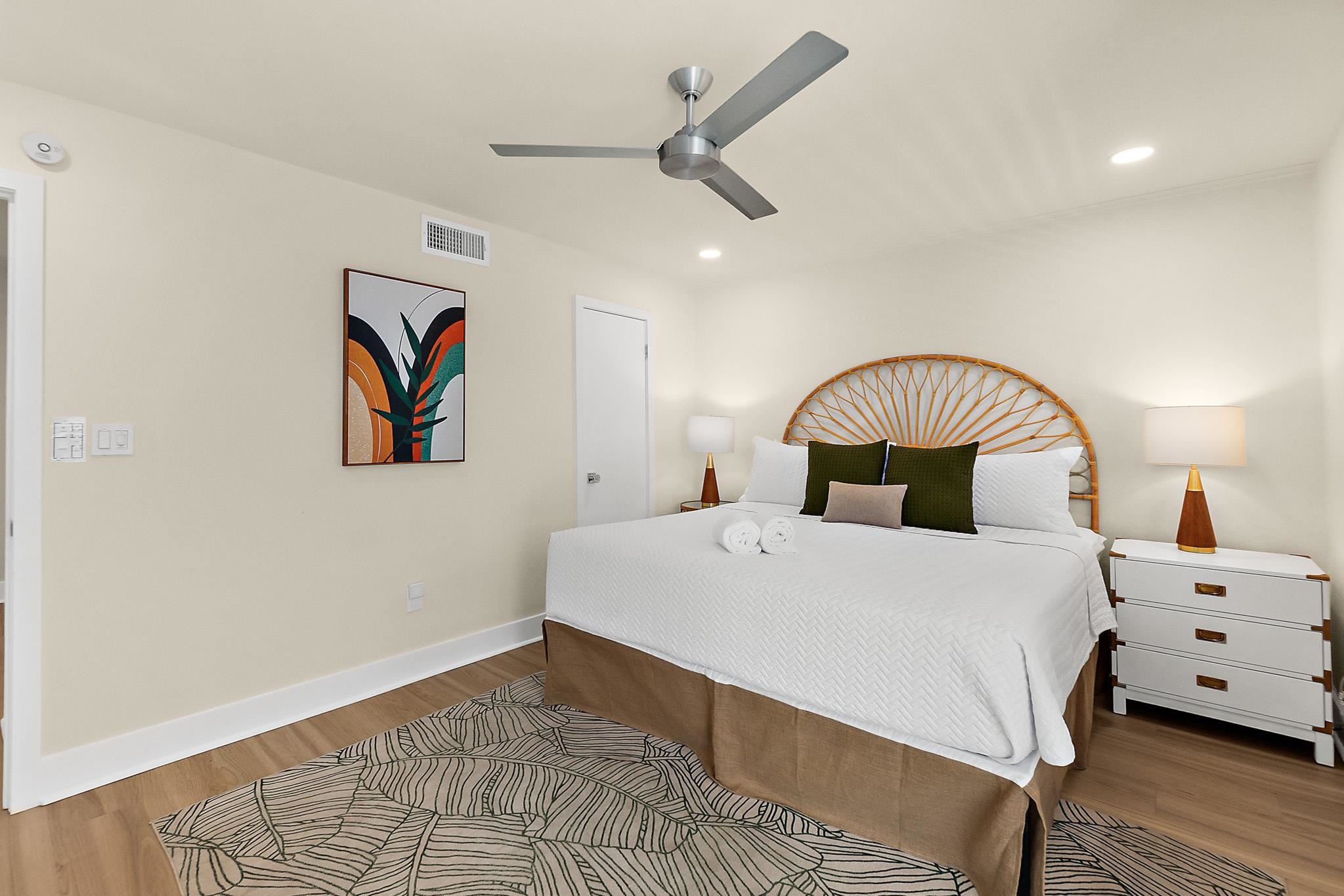 405 Flagler Boulevard, Unit 8A St. Augustine, FL 32080 - Photo 17 of 35 a bedroom with a bed and a painting on the wall