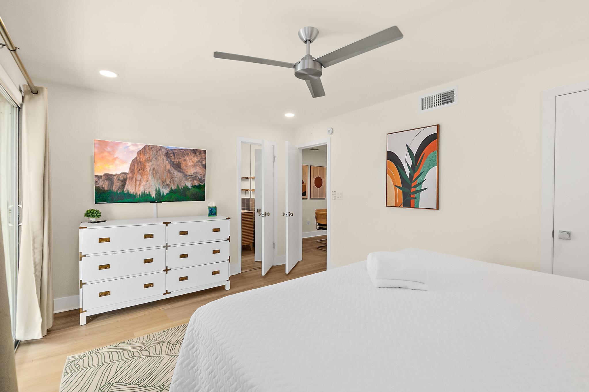 405 Flagler Boulevard, Unit 8A St. Augustine, FL 32080 - Photo 19 of 35 a bedroom with a bed a dresser and painting on the wall