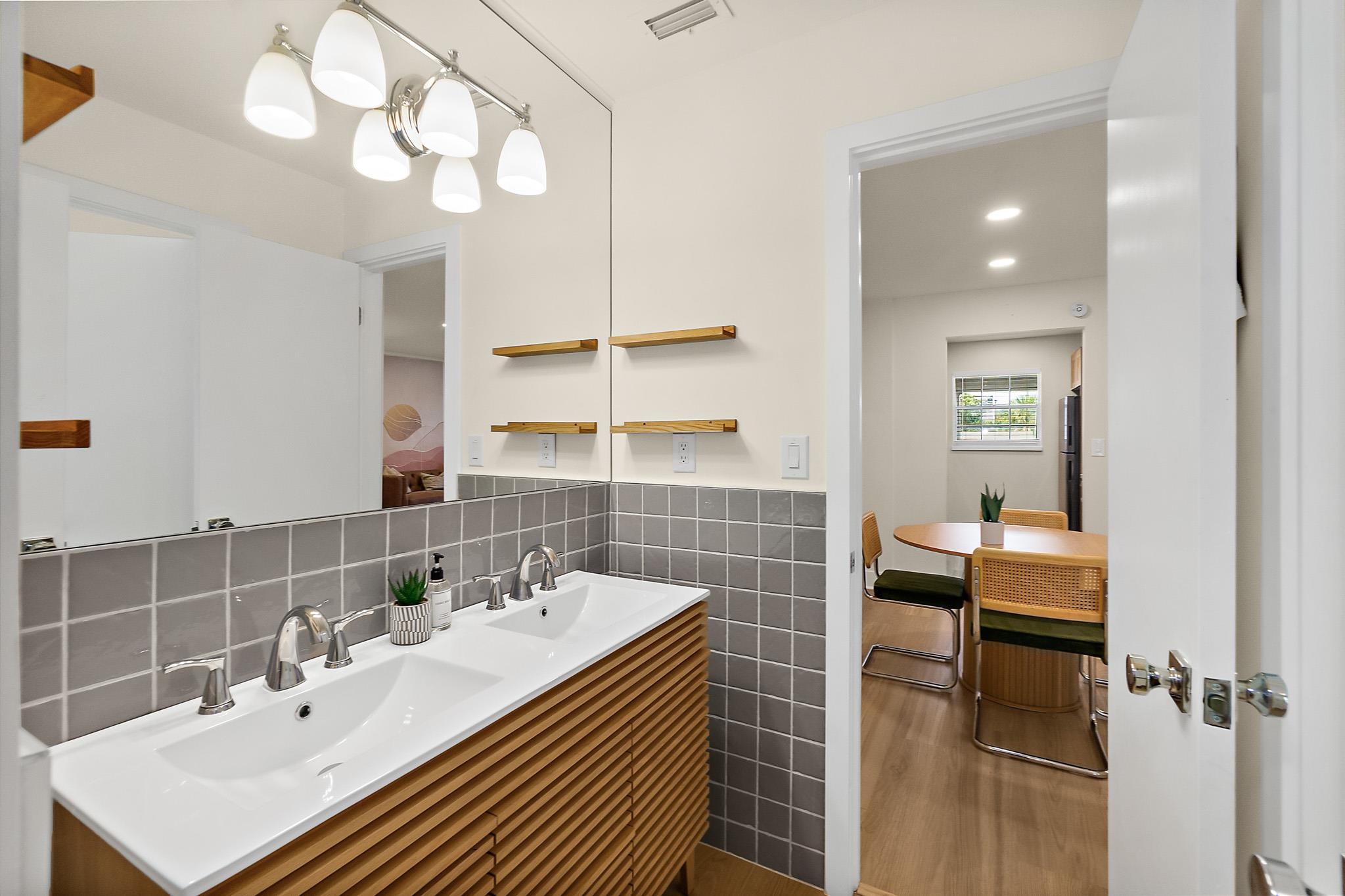 405 Flagler Boulevard, Unit 8A St. Augustine, FL 32080 - Photo 22 of 35 a bathroom with a sink vanity granite and a mirror