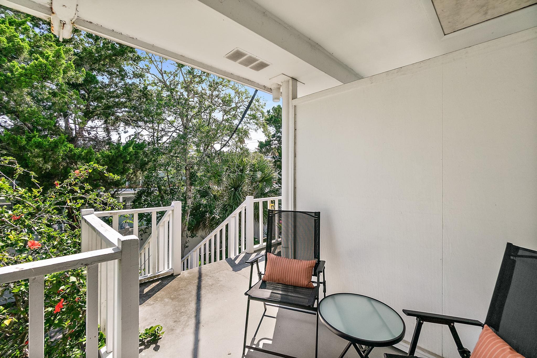 405 Flagler Boulevard, Unit 8A St. Augustine, FL 32080 - Photo 24 of 35 a balcony with table and chairs