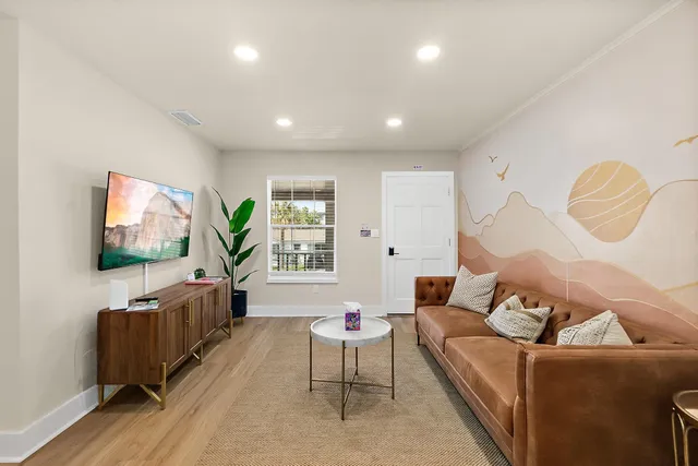 a living room with furniture and a flat screen tv